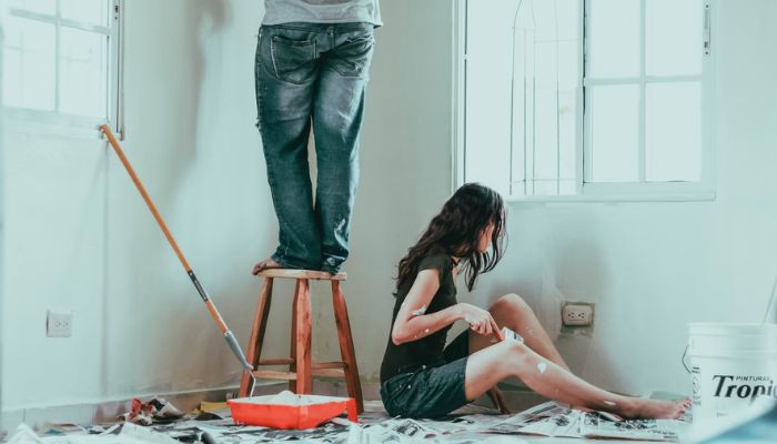 couple painting walls white